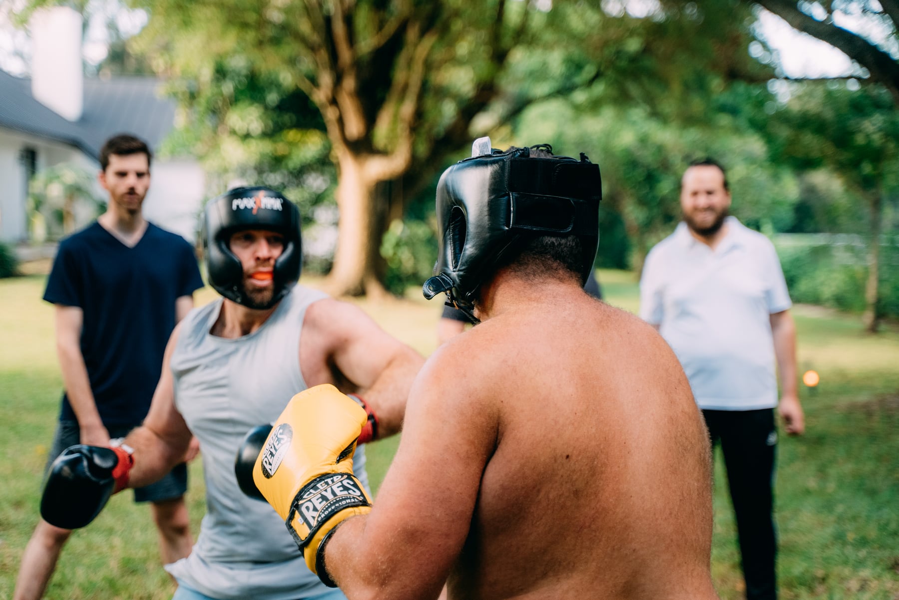 Men practicing boxing outdoors at Ahdama